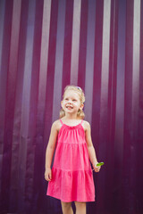 Child with hearing problem and cochlear implant plays in street, deaf kid began to hear. Hearing loss in childhood and treatment concept. Inclusion and disability.