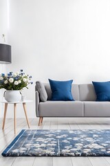 Patterned carpet in front of grey couch with blue pillows in white loft interior with flowers Real photo
