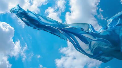 Blue fabric billowing against sky