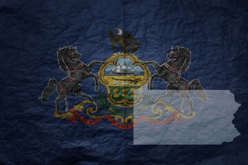 big national flag and map of pennsylvania state on a grunge old paper texture background