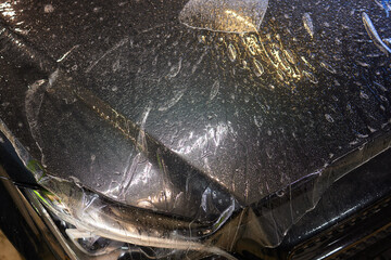 Applying protective film to car hood for added durability