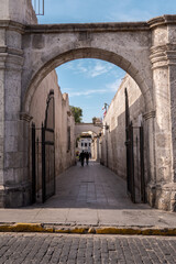 stone arch entrance that leads to a narrow street