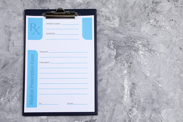 Medical prescription form with empty fields on grey textured table, top view. Space for text