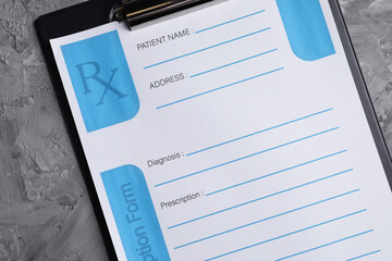 Medical prescription form with empty fields on grey textured table, top view
