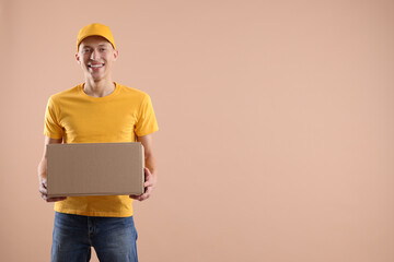 Happy courier with parcel on beige background. Space for text