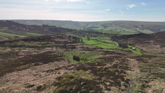 Aerial drone footage flying over an abandoned rural farm building.