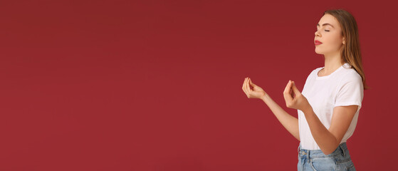 Beautiful young woman meditating on red background. Zen concept