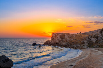 Seascape. Sunset on the sea coast, beautiful rocks on the shore of the Azov Sea