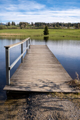 Wooden footbridge in the Schwarzenberger Weiher, a moor lake near Oy-Mittelberg in the southern Allgäu, Germany. The lake is considered the warmest bathing lake in the Allgäu 