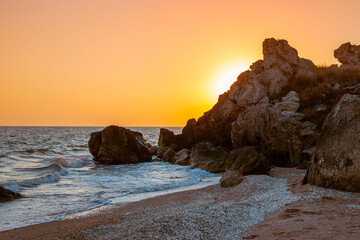 seascape. sea and rocky coast of Crimea at sunset, General beaches of the Azov Sea