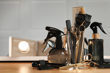 Set of hairdresser tools on table in salon, space for text