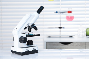 Laboratory analysis. Modern medical microscope on white table indoors, space for text