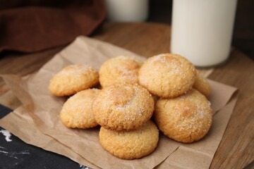Tasty sweet sugar cookies and milk on wooden table, closeup