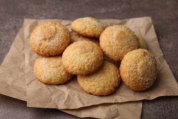 Tasty sweet sugar cookies on brown table, closeup