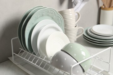 Many different clean dishware and cups on white table indoors