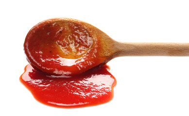 Ketchup, tomato sauce in wooden spoon isolated on white background