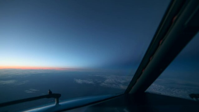 Day to night timelapse seen from cockpit of an airplane forward look high in the sky just after sunset with earth's shadow