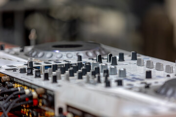 Selective focus of Professional DJ player, DJ mixer to play record players like a musical instrument and create new sounds, To control and manipulate multiple audio signals, Music and recreation.