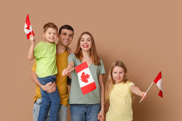Happy family with flags of Canada on brown background