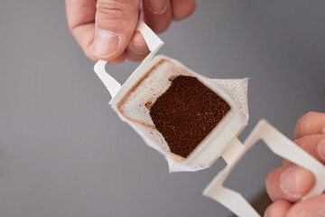 brewing process,a bag filled with boiling water for drip coffee in a cup,top view.