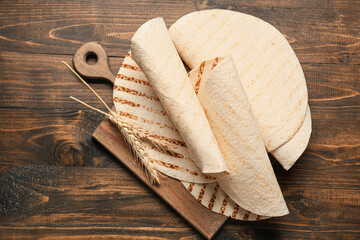 Composition with lavash on wooden background