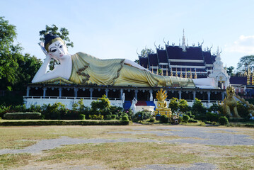Outdoor Buddhist reclining Buddha at Wat Phra That Suthon Mongkhon Khiri Samakkhi Tham. It is a...