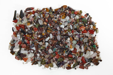 Heap of natural semiprecious stones isolated on white background. Texture of colorful gems