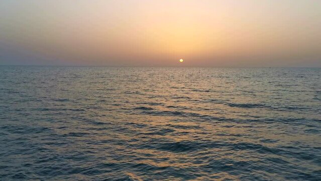  Sunset sun on the sea with orange reflections from the boat en route 