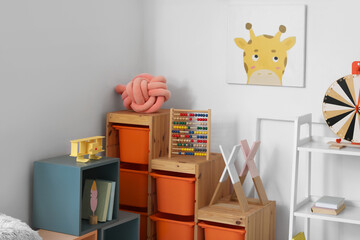 Modern furniture with toys in interior of children's room