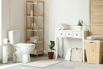 Interior of light bathroom with ceramic toilet bowl