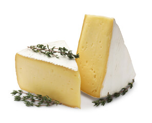 Pieces of tasty camembert cheese and thyme isolated on white
