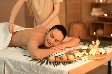 Obraz na płótnie Canvas Young woman getting back massage in spa salon