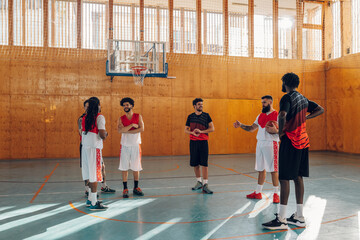 Group of professional diverse players training basketball together