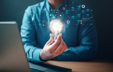 imagination, insight, invention, solution, strategy, visionary, inspiration, innovation, light bulb, creativity. A man is holding a light bulb in his hand. Concept of innovation and creativity.