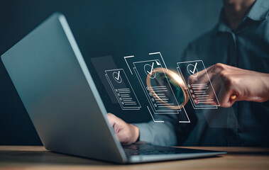 innovation, global, job, marketing, programming, security, research, information, strategy, network. A man is using a laptop with a magnifying glass on it. Concept of searching for something.