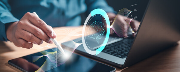 future, strategy, analysis, graph, management, marketing, science, tech, research, innovation. A person is using a laptop to draw a picture of a brain, with the person's hand hovering over the screen.