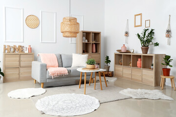Interior of modern stylish living room with grey sofa and plaid