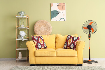 Interior of stylish living room with modern electric fan and yellow sofa
