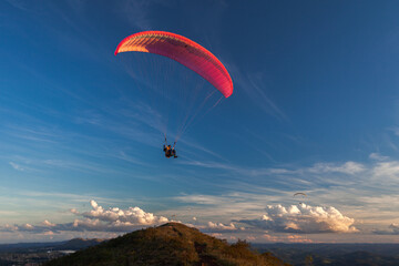 Paragliders in the sky at sunset