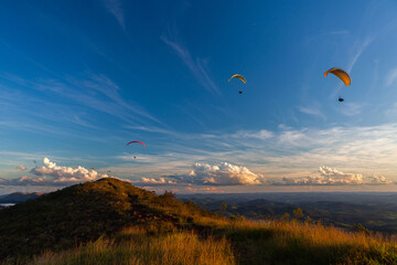 Paragliders in the sky at sunset