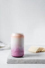 Peach and blueberry yogurt in a can shaped glass, peach blueberry yogurt in a glass shaped like a can, Aesthetic cafe ombre drink in a can glass