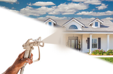 Professional Spray Painter Holding Spray Gun Spraying New House Over White Surface.