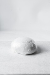 fondant or gumpaste for decorating cake on a white marble countertop, making white fondant on a marble surface