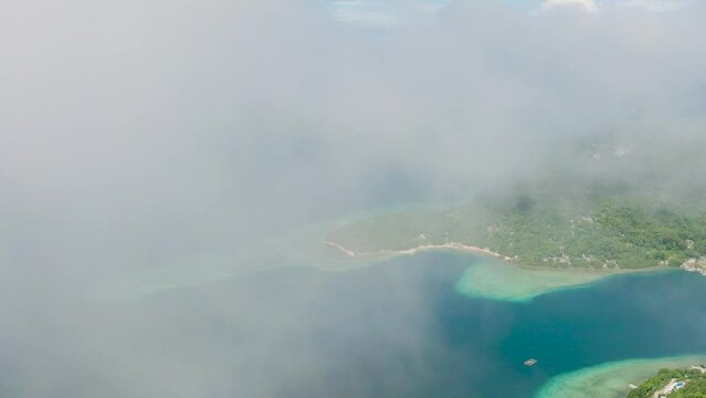 Romblon Island with blue sea covered with fogs. Romblon, Philippines.