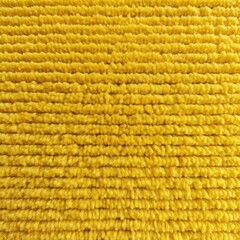 Yellow close-up of monochrome carpet texture background from above. Texture tight weave carpet blank empty pattern with copy space for product design