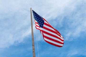 American Flag for Memorial Day or 4th of July. American flag waving in the wind. Flag of the USA. National waving flag of united states on blue sky. Independence day. Patriotic symbol