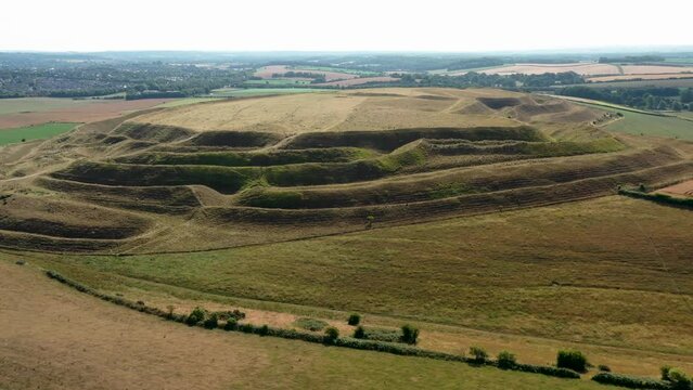 Maiden Castle, Dorset UK. Fly in video E. over W. entrance prehistoric Iron Age hillfort ramparts and ditches dates from 4000 BC causewayed enclosure