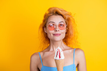 Woman with a cornet ice cream. Delicious gelato in waffle cone in summer. Girl eating ice cream in...