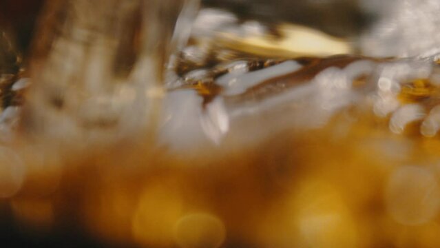 Whiskey being poured and swirling