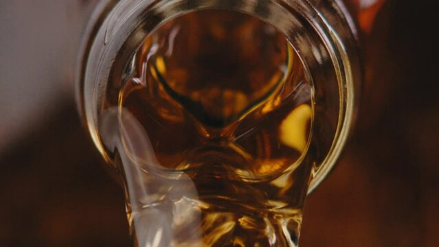Whiskey poured out of bottle